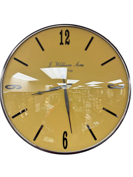 Round wall clock with yellow face and black numbers on a purple background